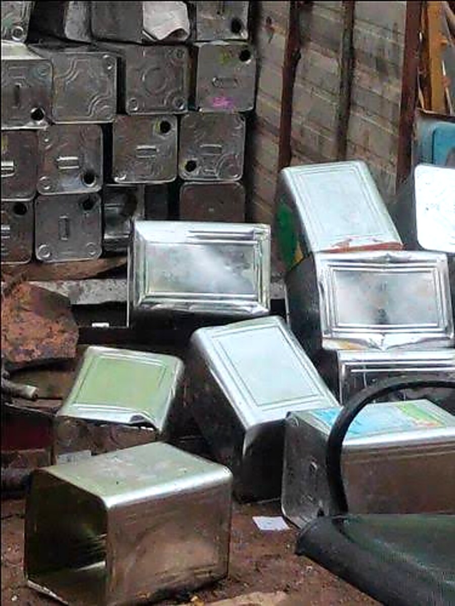 Stacked scrap tin containers at the yard