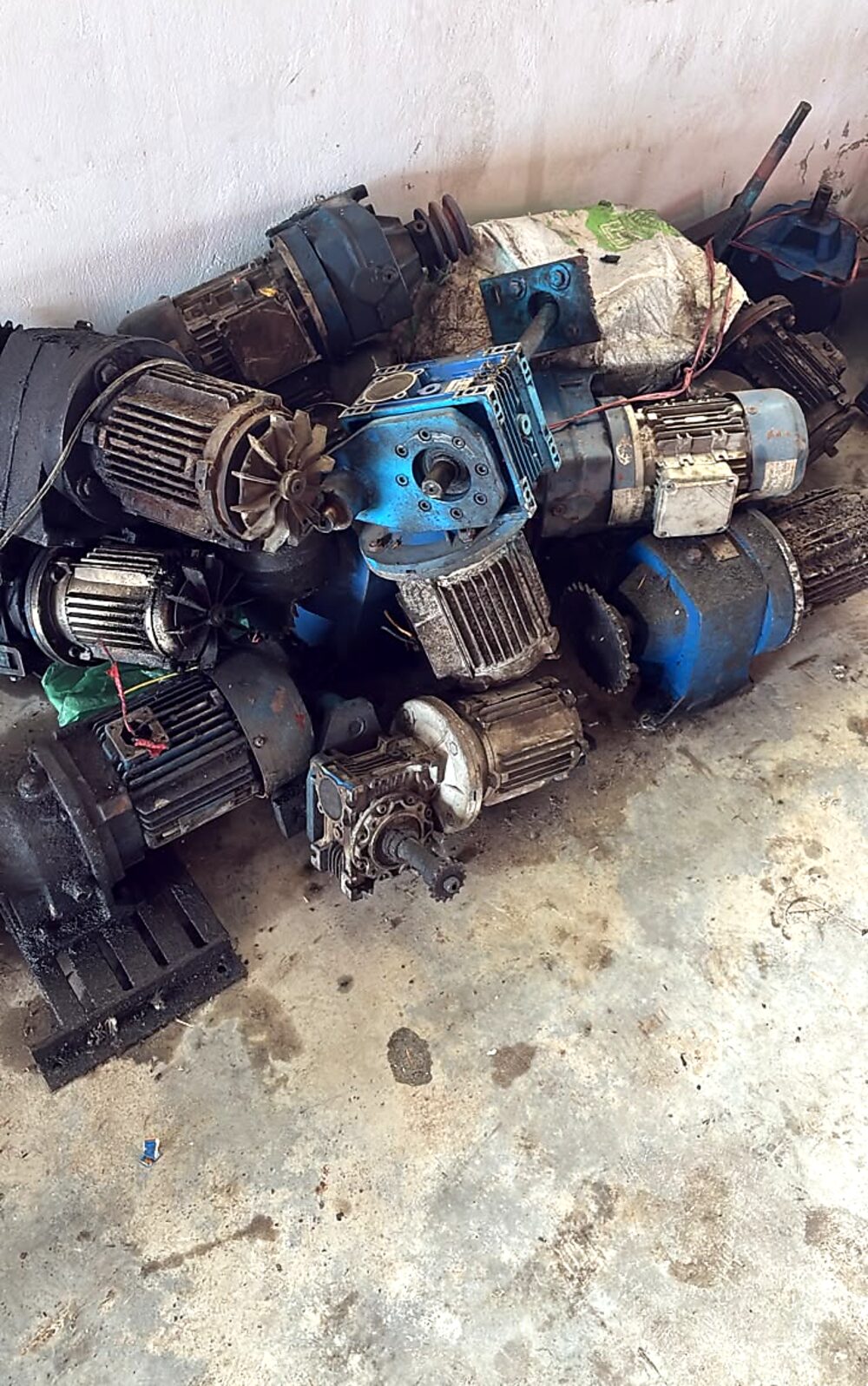 Scrap electric motors and gearboxes awaiting copper recovery