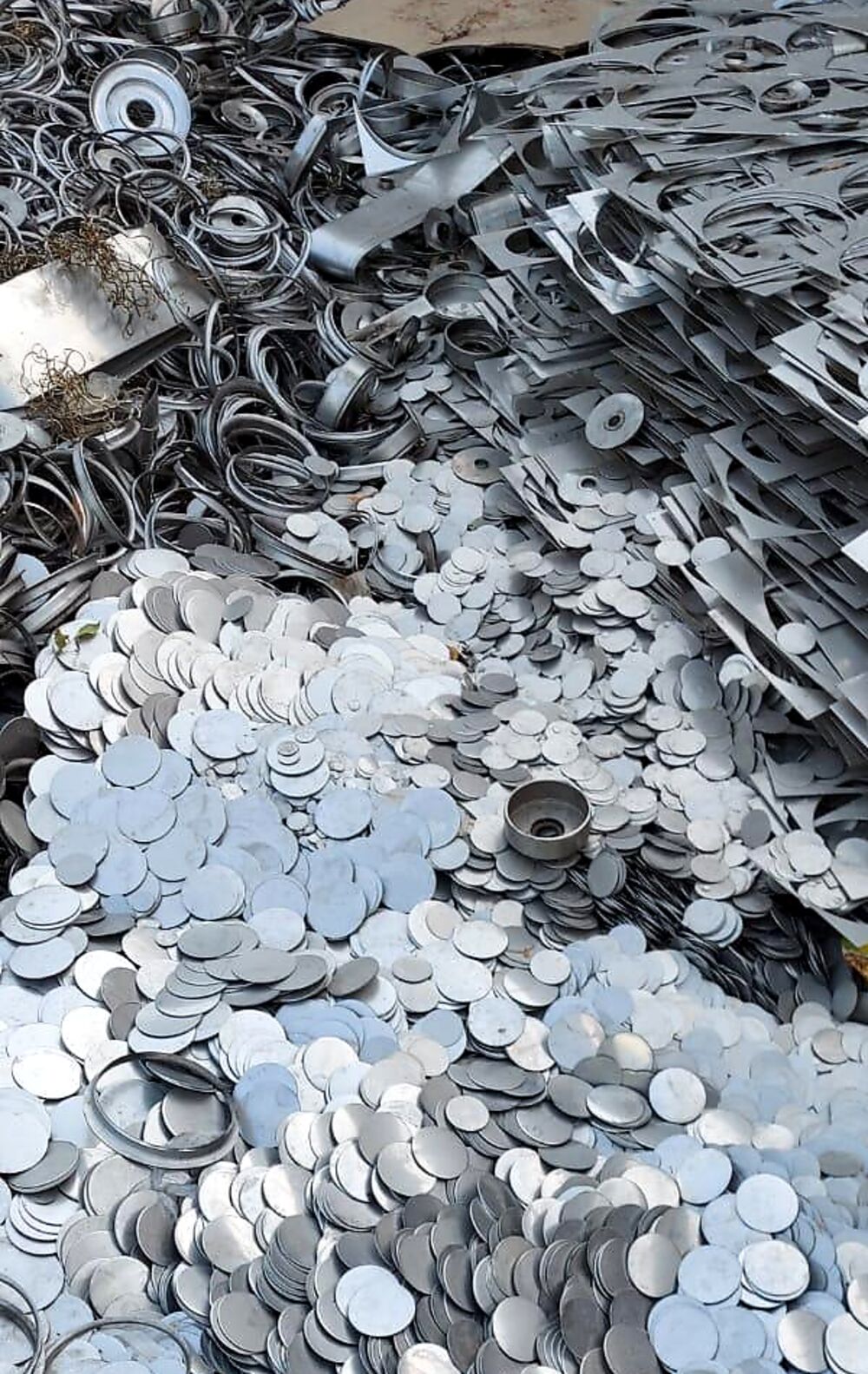 Laser-cut sheet metal skeletons and blanking discs collected from a fabrication unit