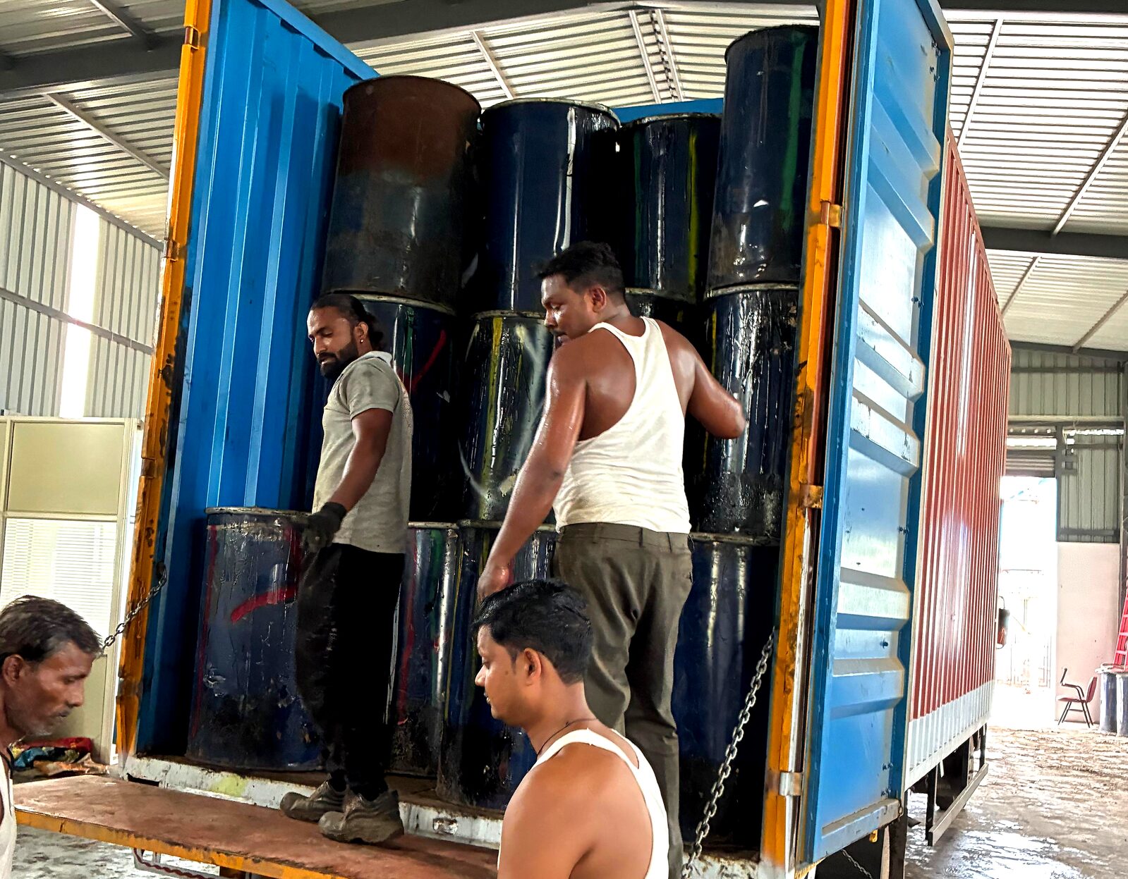 Our team loading used-oil drums onto a collection vehicle